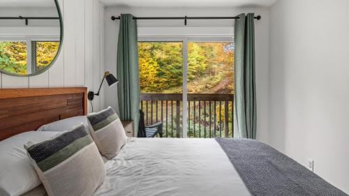 a bedroom with a bed and a large window at Bolton Condo condo in Bolton