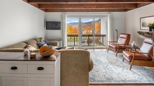a living room with a couch and a balcony at Bolton Condo condo in Bolton