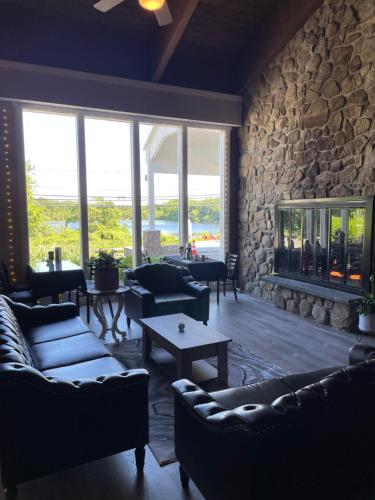 a living room with couches and a stone wall at Hotel Cape Cod in Falmouth