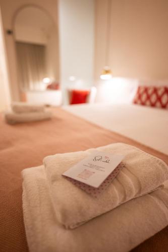 a hotel room with a towel on a bed at Sol i Vida Hotel - Adults Only in Porto Cristo