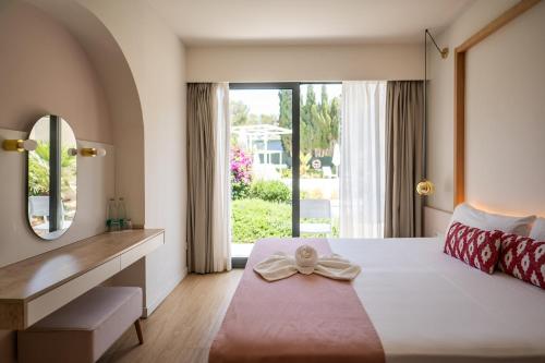 a bedroom with a large bed and a mirror at Sol i Vida Hotel - Adults Only in Porto Cristo
