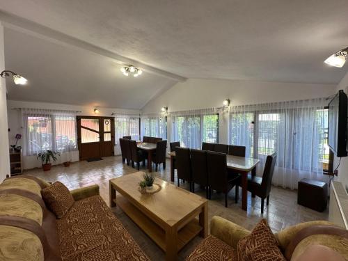 a living room with a couch and a table at Pensiunea Apuseni in Vidra
