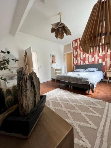 - une chambre avec un lit, une table et un tapis dans l'établissement Château de la PLUMASSERIE, à Fontenay-Trésigny