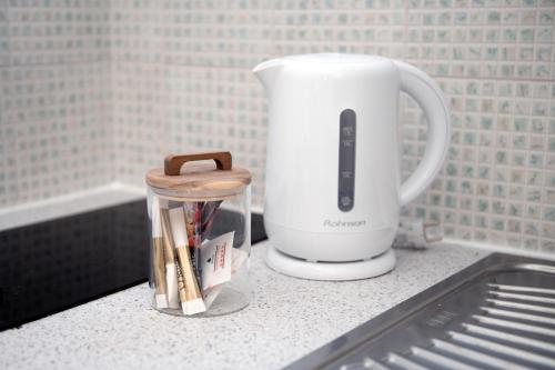 a white appliance sitting on a counter in a kitchen at Marianthi Apts Anissaras in Hersonissos