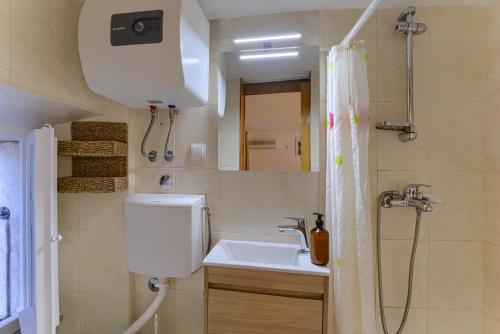 a bathroom with a toilet and a sink and a shower at Guest House City Center in Korčula