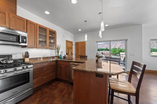 a kitchen with a stove and a counter top at 57 Robber's Roost in Moab