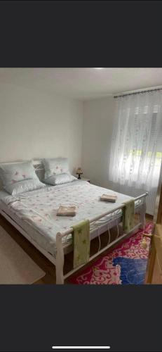 a bedroom with a large bed with at PRENOCiSTE SARA in Bihać