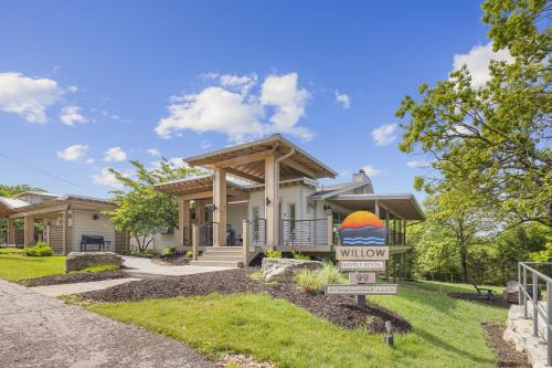a house with a porch and a sign in front of it at Willow - 99 Ridge Lane in Branson