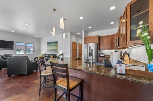 a kitchen and living room with a counter and chairs at 57 Robber's Roost in Moab