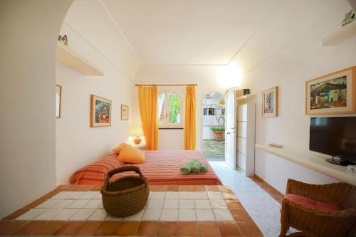 a living room with a couch and a television at La Piccola, Capri in Capri