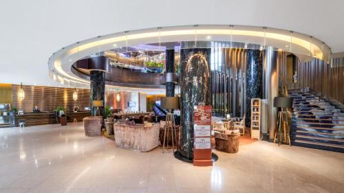 a lobby of a hotel with a large staircase at Crowne Plaza Kunming City Centre by IHG in Kunming