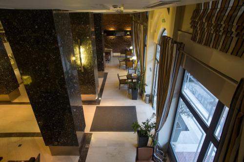 an overhead view of a lobby with tables and chairs at Davitel - Tobacco Hotel in Thessaloniki