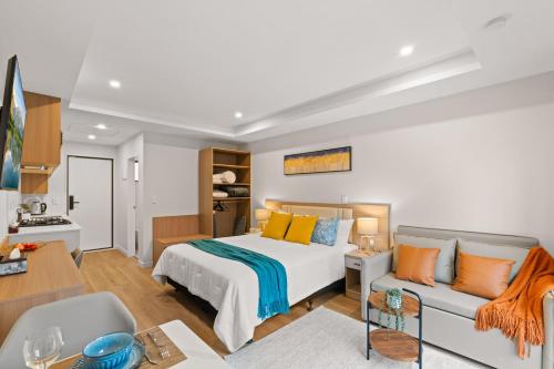 a bedroom with a bed and a couch at Starlet 11 in Lake Tekapo