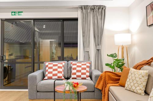 a living room with a couch and a table at Starlet 11 in Lake Tekapo