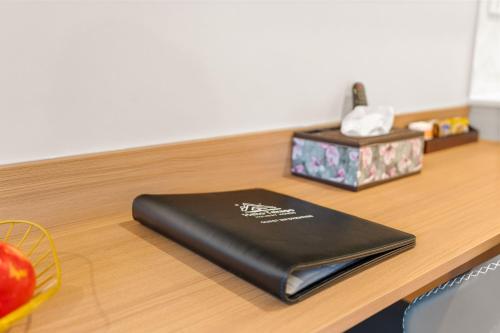 a black notebook sitting on top of a wooden table at Starlet 11 in Lake Tekapo