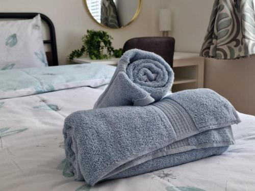 a towel sitting on top of a bed at Luxury City Centre Apartment- Free Parking in Leicester