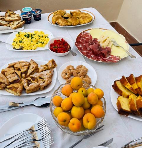 a table with many plates of food on it at Casa castello in Rocca Imperiale
