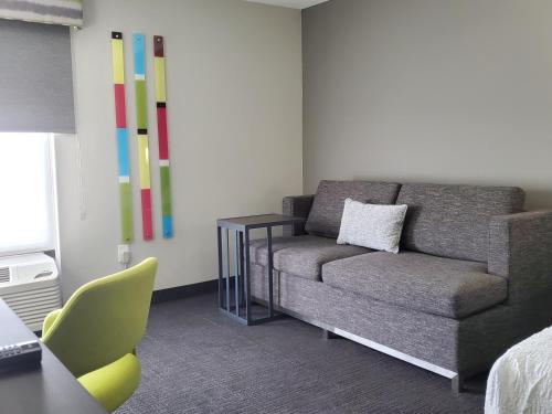 a living room with a couch and a chair at Hampton Inn Olathe in Olathe
