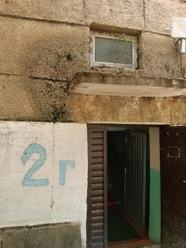 a building with a window and the number at Guest House URUYAT in Naryn