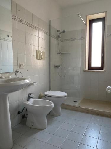 a bathroom with a toilet and a sink and a shower at HYPOGEUM -Le Torri Apartments- in Otranto