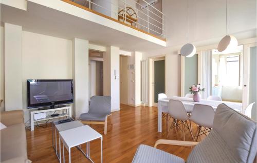 a living room with a dining table and a television at Villino Anna in Viareggio