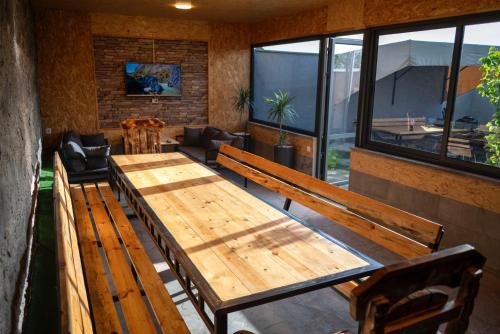 a room with wooden tables and chairs and windows at Payteni House in Nurrnus