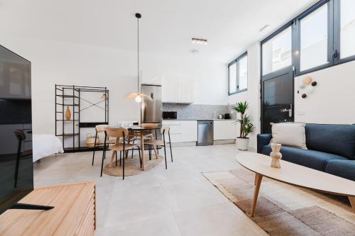 a living room with a couch and a table at Valencia Apartments by Olala Homes in Valencia
