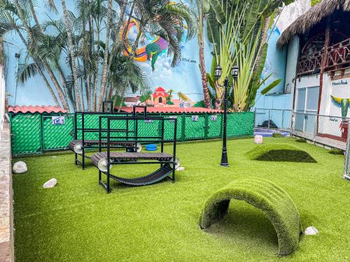 a park with a playground with a swing at Best Western Posada Chahue in Santa Cruz Huatulco