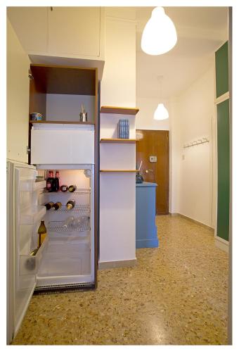 an empty refrigerator with its door open in a room at Casa Gorgone, SeaFront Flat! in Viareggio