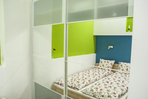 a bed in a room with green and blue at Blue home in the heart of Budapest in Budapest
