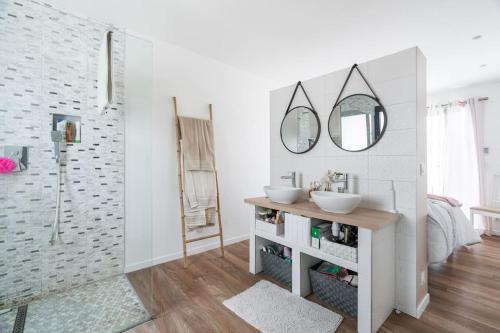 une salle de bain avec deux lavabos et un miroir dans l'établissement A beautiful house with garden, 7 guests, à Argenteuil