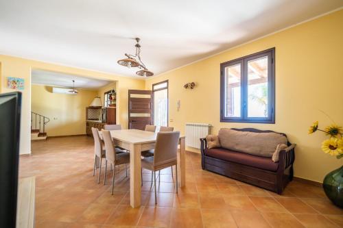 a living room with a table and a couch at Villa Panorama in Trappeto