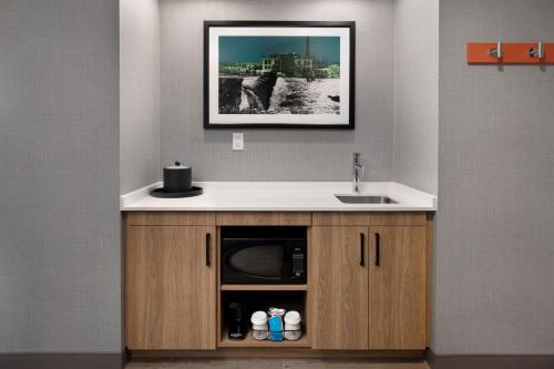 a kitchen with a sink and a microwave at Hampton Inn & Suites Watertown Boston, Ma in Watertown