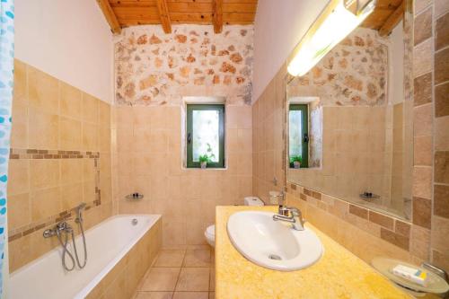 a bathroom with a sink and a tub and a toilet at Villa Hlazeika by Villa Plus in Old Skala