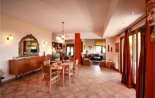 a dining room and living room with a table and chairs at Stunning Home In Finikia in Foinikiá