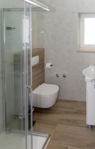 a bathroom with a tub and a glass shower at Apartments Borghese in Pula