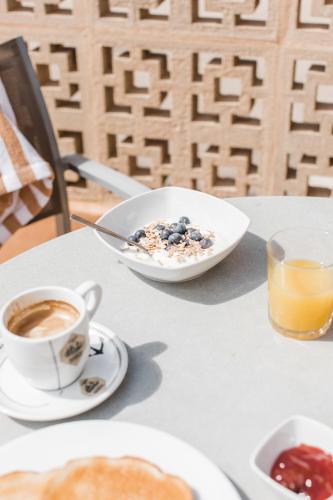 a table with a bowl of cereal and a cup of coffee at Hotel Golf Beach in Santa Ponsa