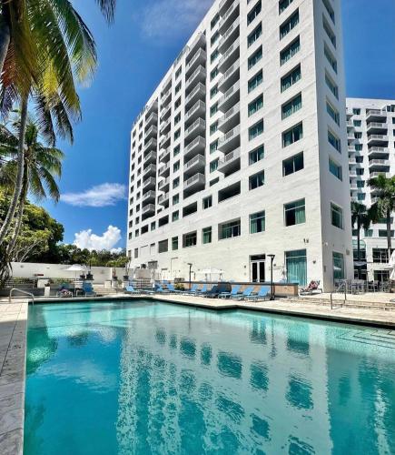 a large building with a swimming pool in front of a building at GalleryOne Doubletree Hilton GC Turtle Cove in Fort Lauderdale