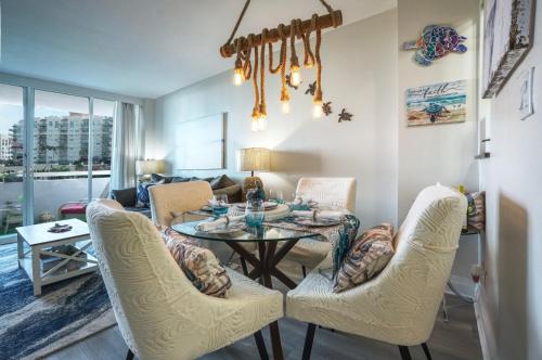 a living room with a table and chairs at GalleryOne Doubletree Hilton GC Turtle Cove in Fort Lauderdale