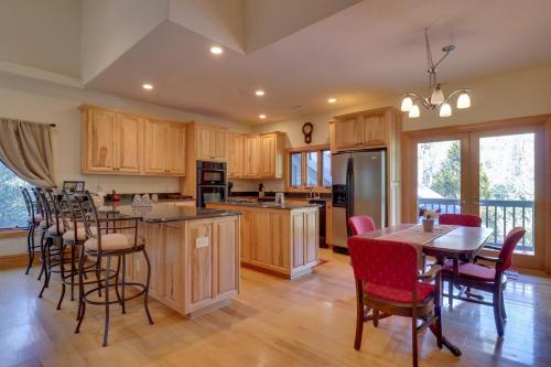 a kitchen with wooden cabinets and a table and chairs at 11 Mi to Ski Sapphire Heaven South Apt with Porch in Highlands