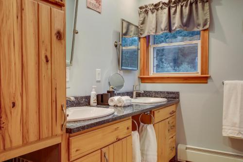 a bathroom with a sink and a mirror at Adirondack Retreat with Heated Pool and Scenic Views! in North Creek