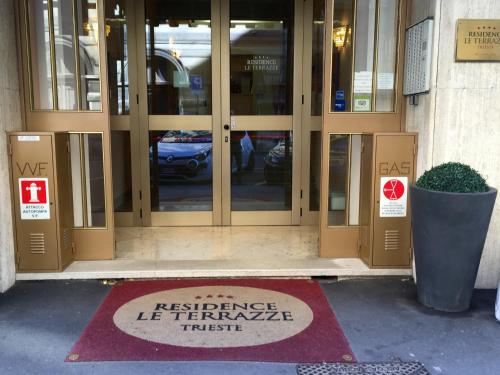 a sign in front of a entrance to a building at Residence Le Terrazze in Trieste
