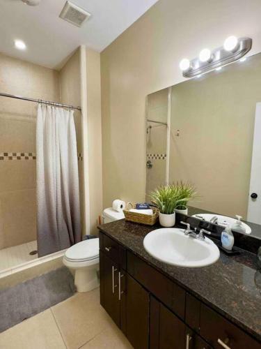 a bathroom with a sink and a toilet and a shower at Luxury Condo with Pool and Jacuzzi in Mission