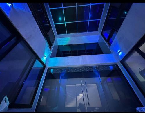 a ceiling with blue lights in a building at Sea, Hill & Forest View Villa in Dongri