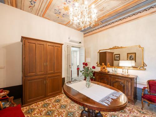 a living room with a table and a mirror at PALAZZO CHERCHI in Dorgali