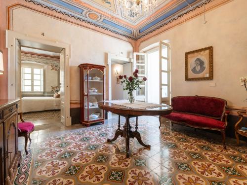 a living room with a table and a couch at PALAZZO CHERCHI in Dorgali