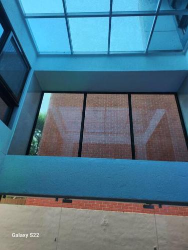 a window in a building with a blue ceiling at Sea, Hill & Forest View Villa in Dongri