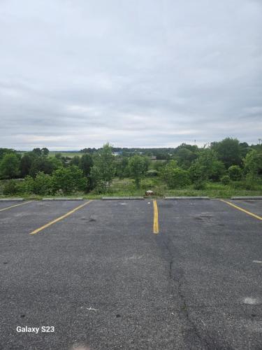 an empty parking lot with a yellow line in the middle at Quality Inn Dublin I-81 in Dublin