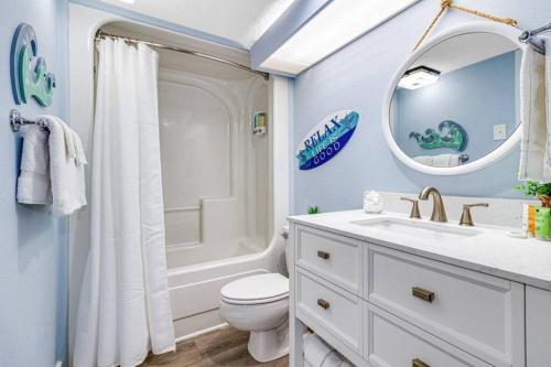 a bathroom with a toilet and a sink and a mirror at Lux High-End Haven Oceanfront Suite! Dogs OK! 1606 in Myrtle Beach