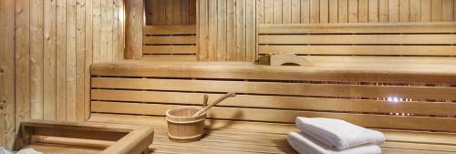 a sauna with a trash can and two towels at Luksusowy apartament z widokiem, basenem i sauną Hanza Tower Szczecin in Szczecin